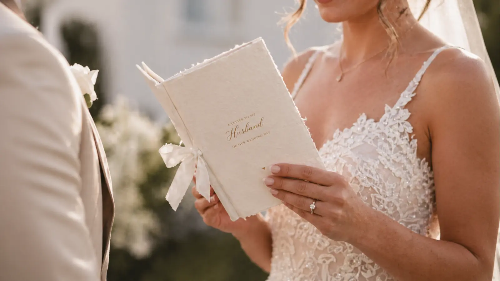 bride reading wedding vows from book during ceremony