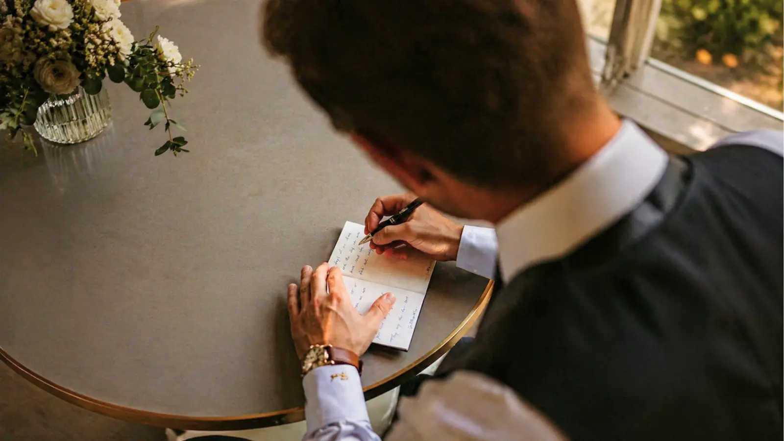 groom writing wedding vows before ceremony