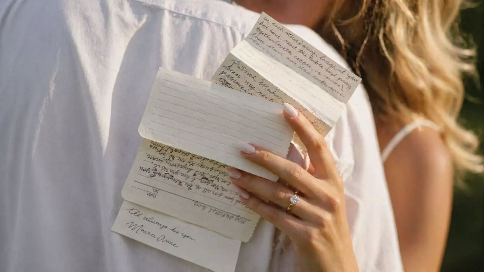 Close-up of bride holding handwritten wedding vows