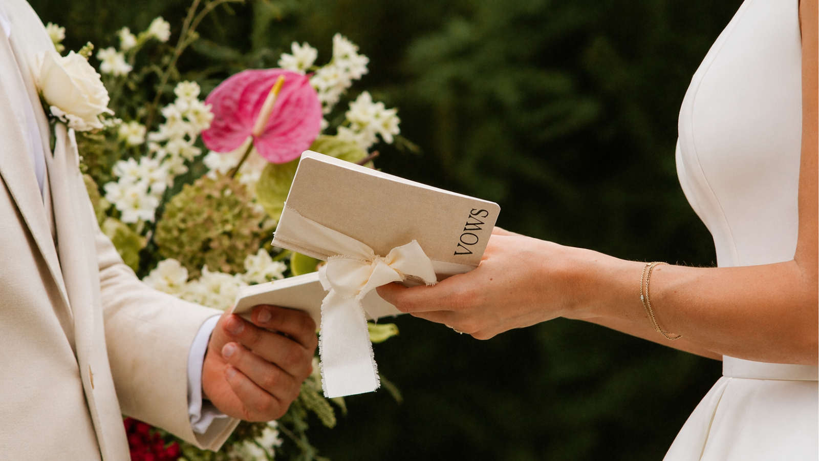 Bride holding a vow booklet during wedding ceremony