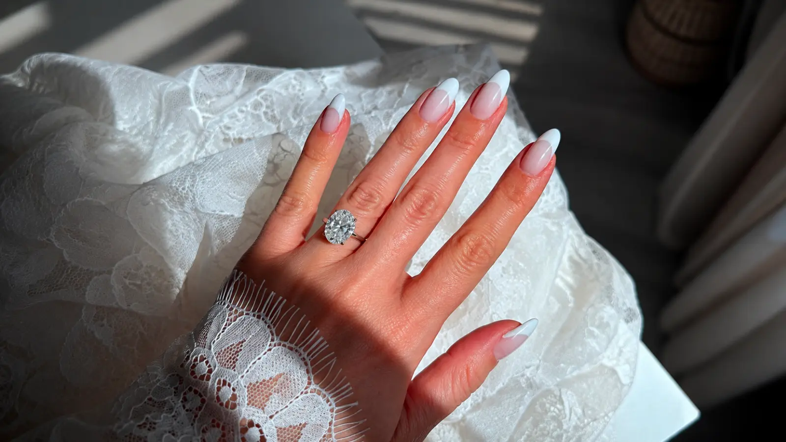 Almond French tip bridal nails with lace sleeve and diamond ring