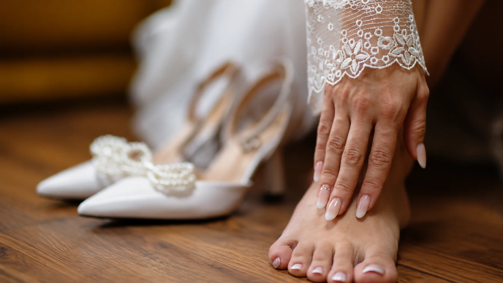 French manicure and pedicure coordinated with bridal heels and lace sleeves