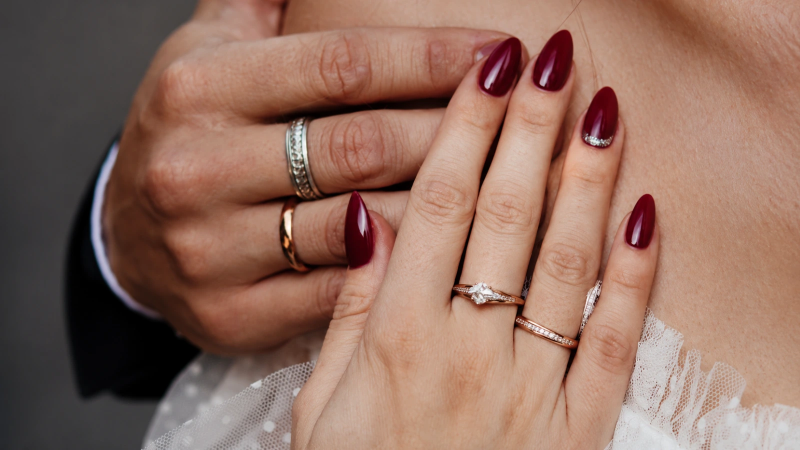 Deep burgundy fall wedding nails with bridal rings