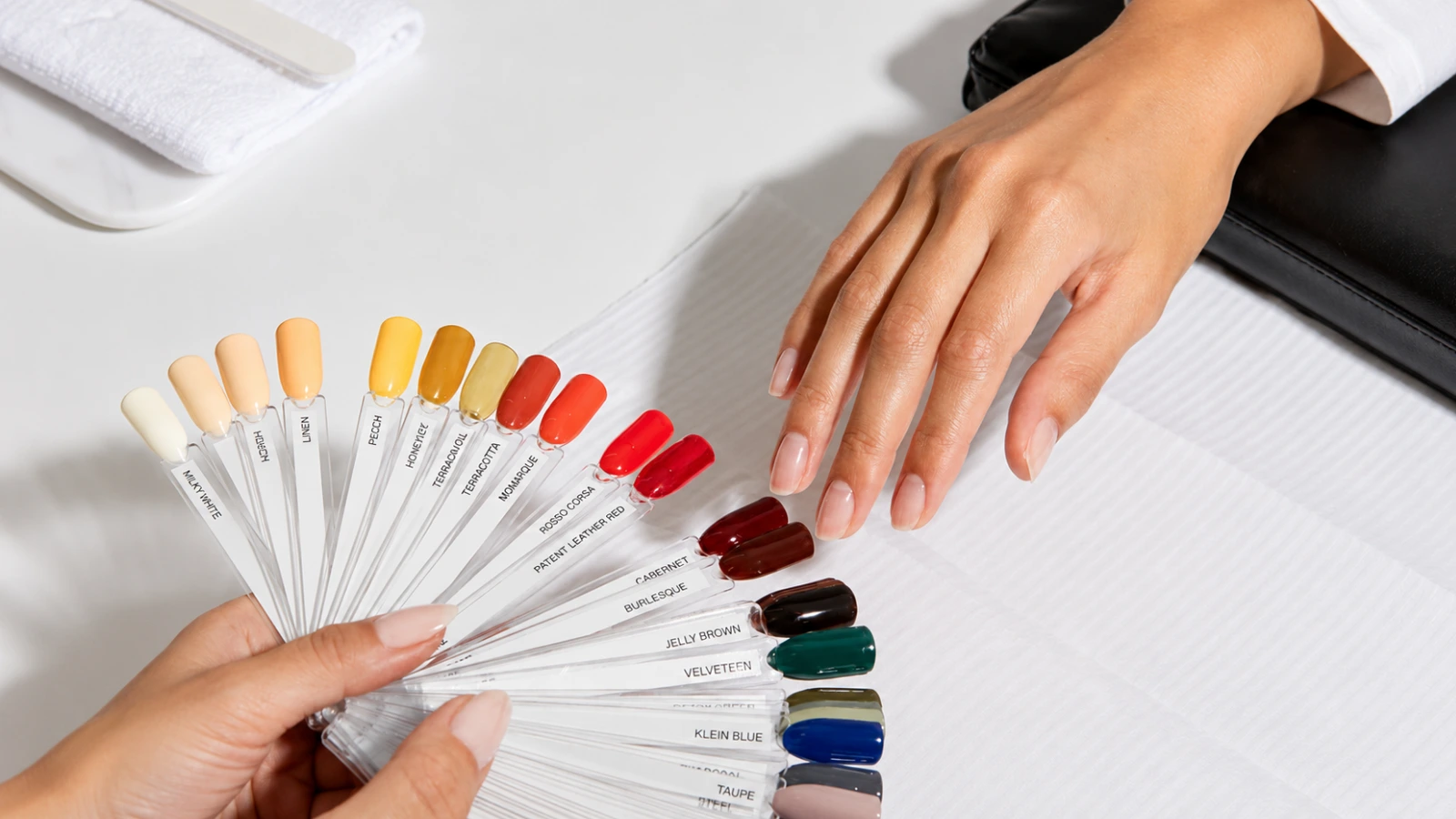 Bride selecting wedding nail colors from manicure swatches before the wedding