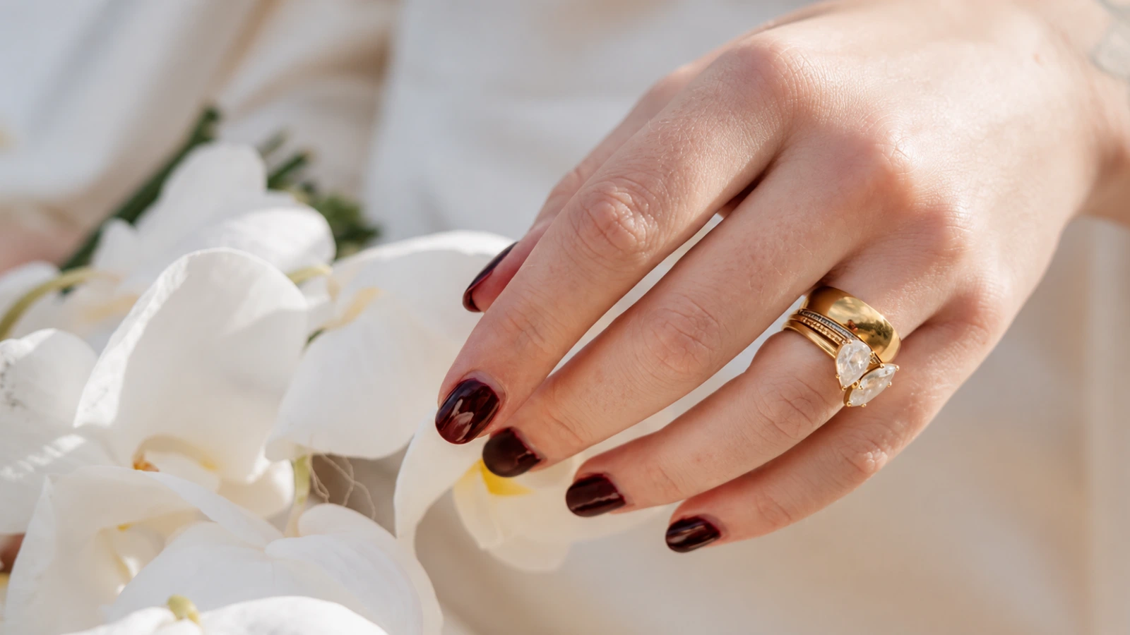 Neutral nude wedding nails with navy satin dress