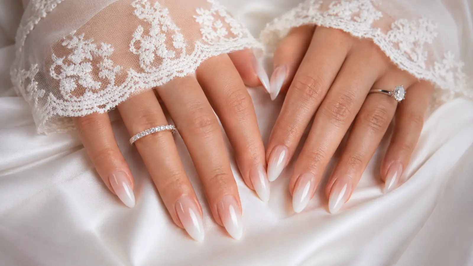 Ombré white wedding nails with lace bridal sleeves and satin fabric