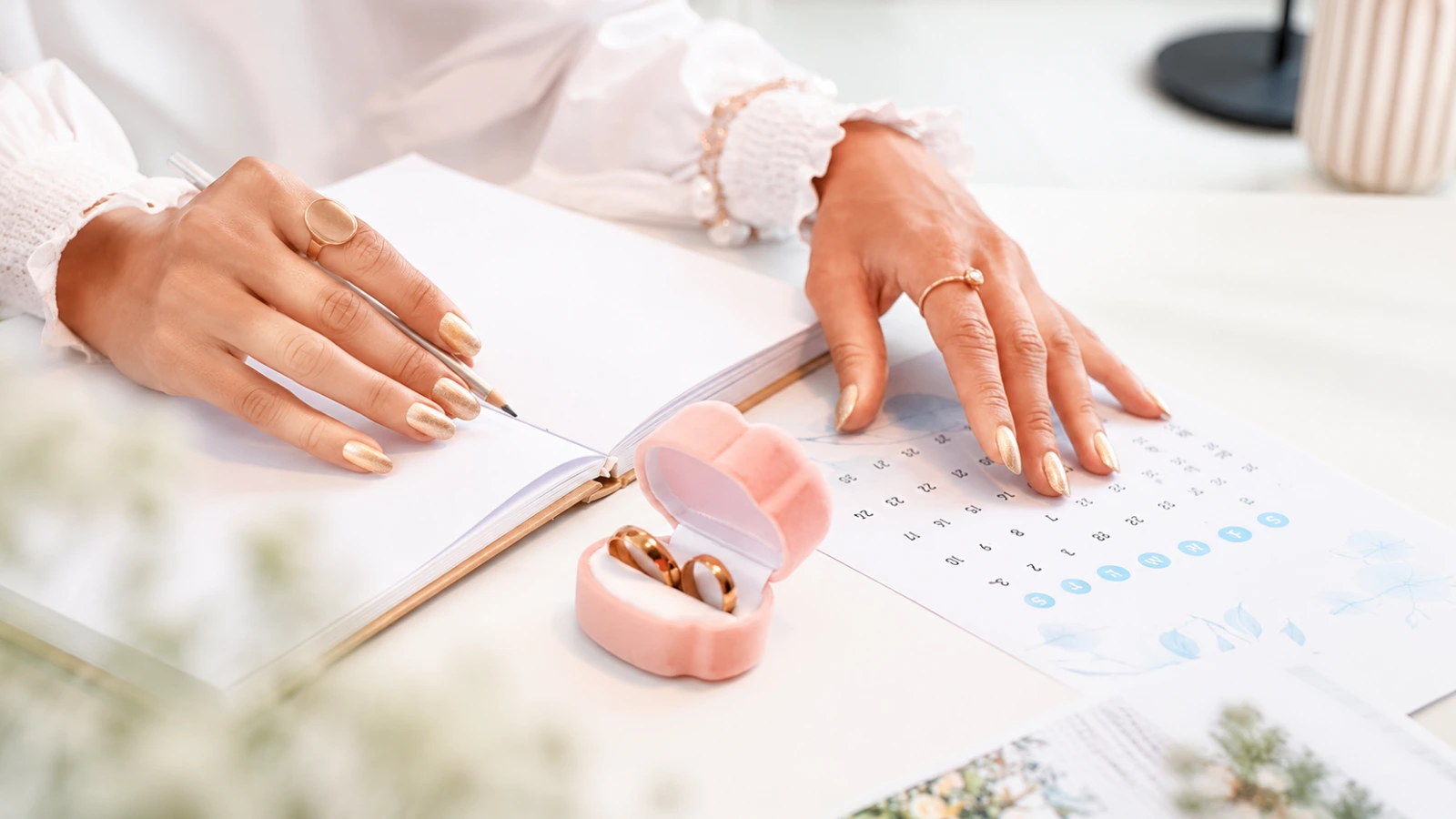 Bride planning wedding nail appointment on a calendar before her wedding