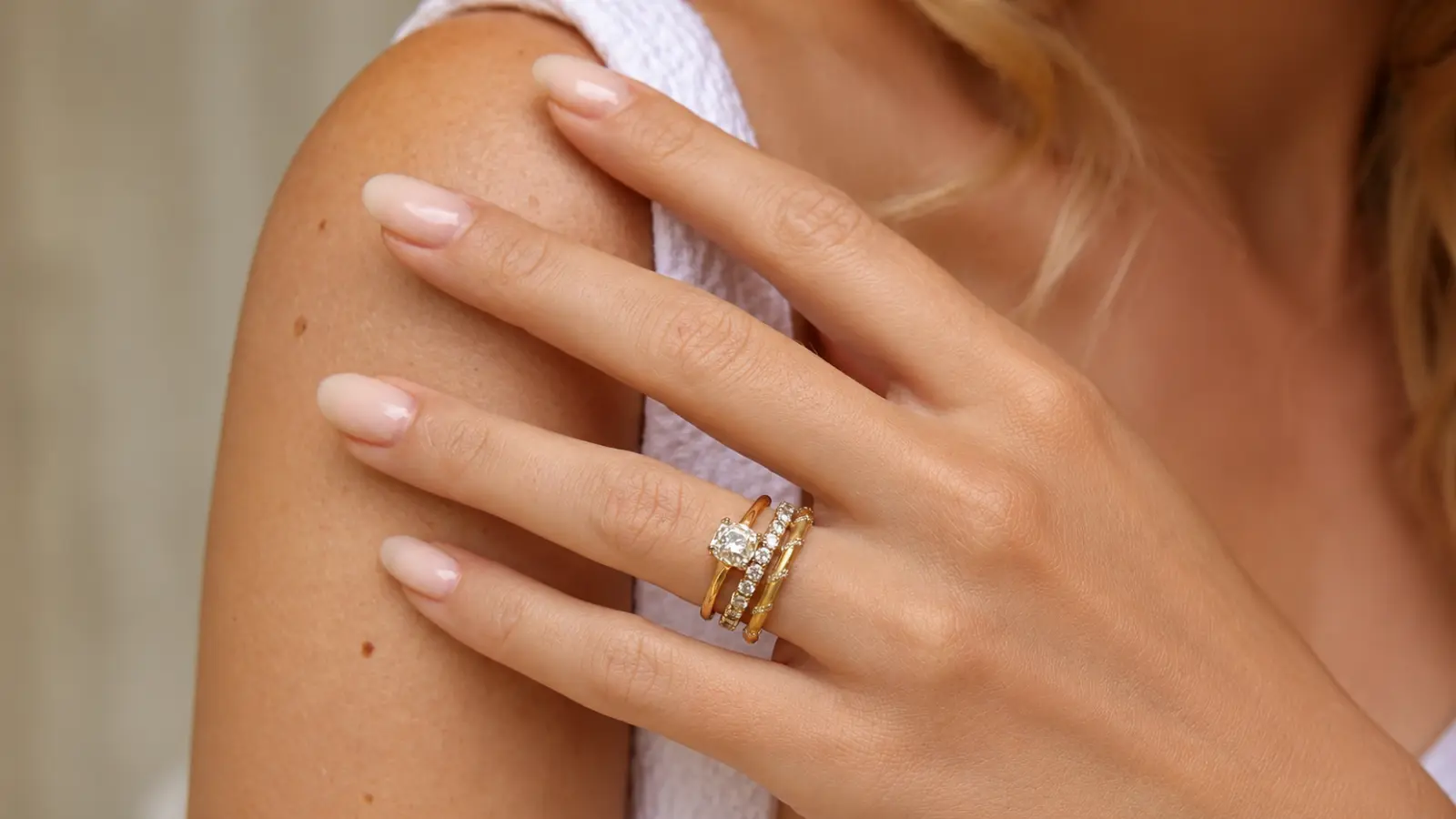 Bride choosing an engagement ring and wedding band set during a jewelry appointment.