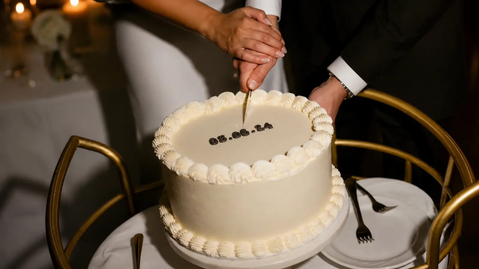 Classic simple wedding cakes being cut during a wedding reception