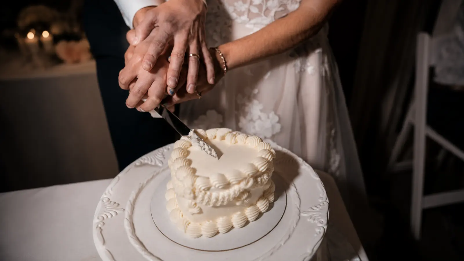 Bride and groom cutting their wedding cake together during the reception
