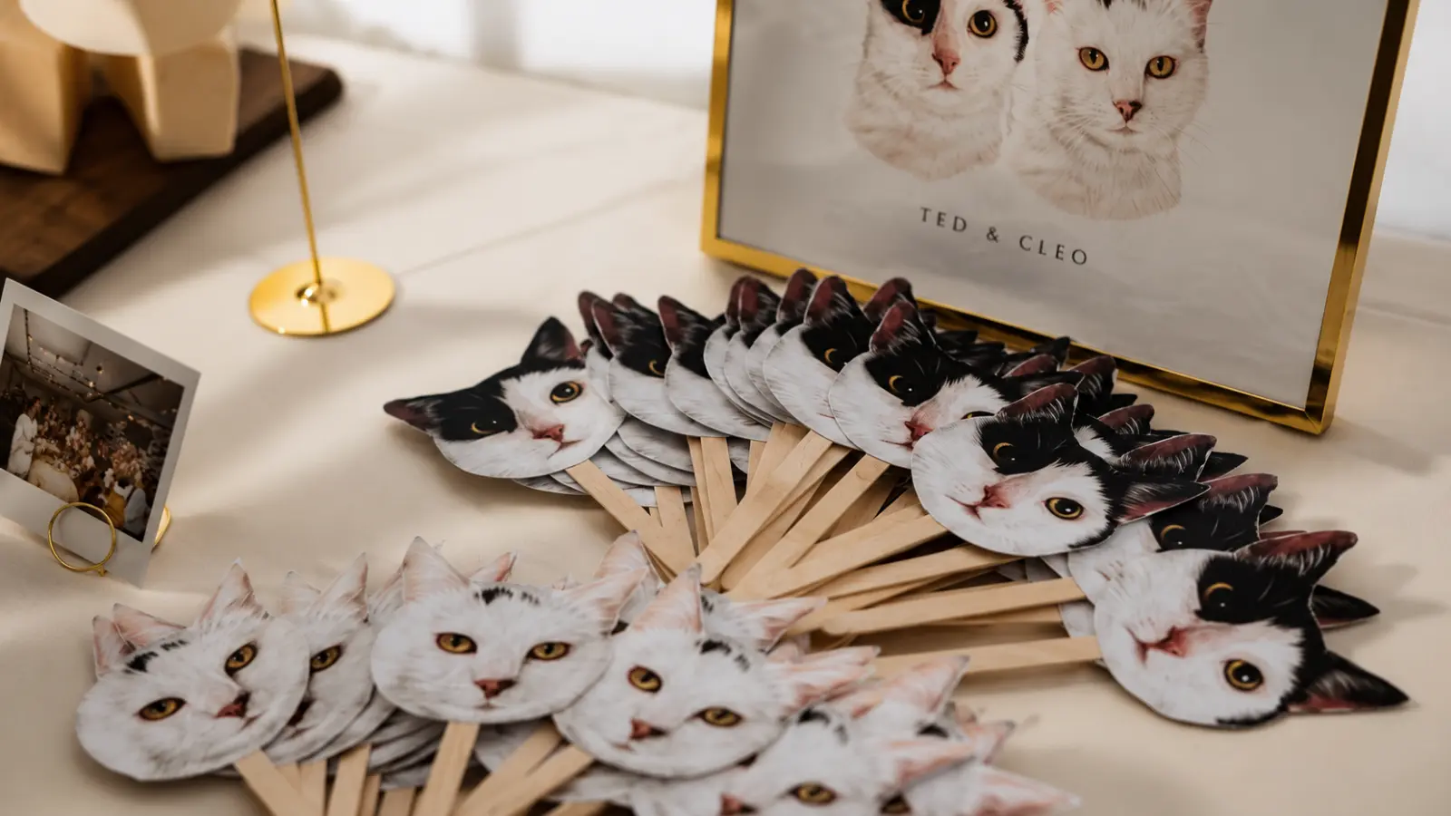 Personalized wedding fans designed with illustrations of the couple's cats