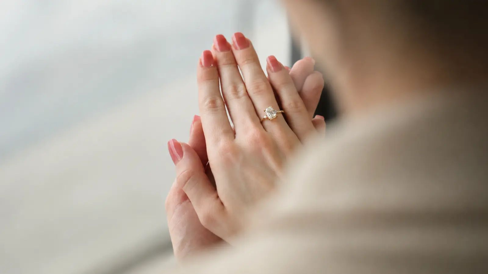 Close-up of a diamond engagement ring on a bride’s hand before adding a wedding band.