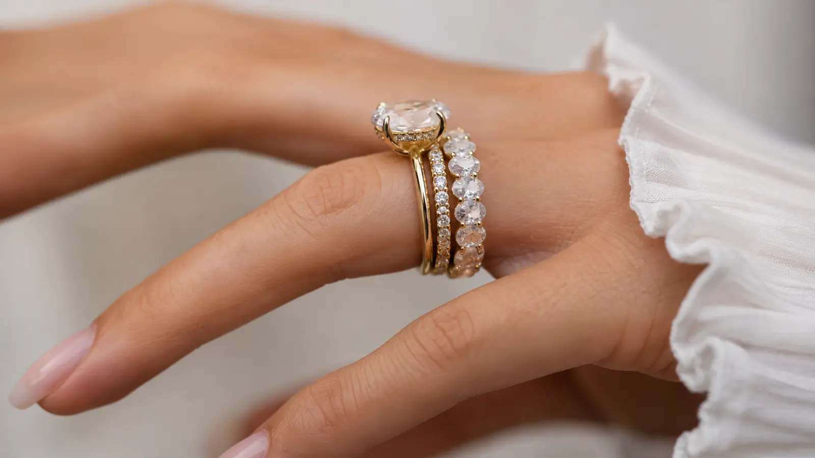 Close-up of diamond wedding rings stacked together with gold bands, showing bridal ring combinations and layered wedding jewelry styles.