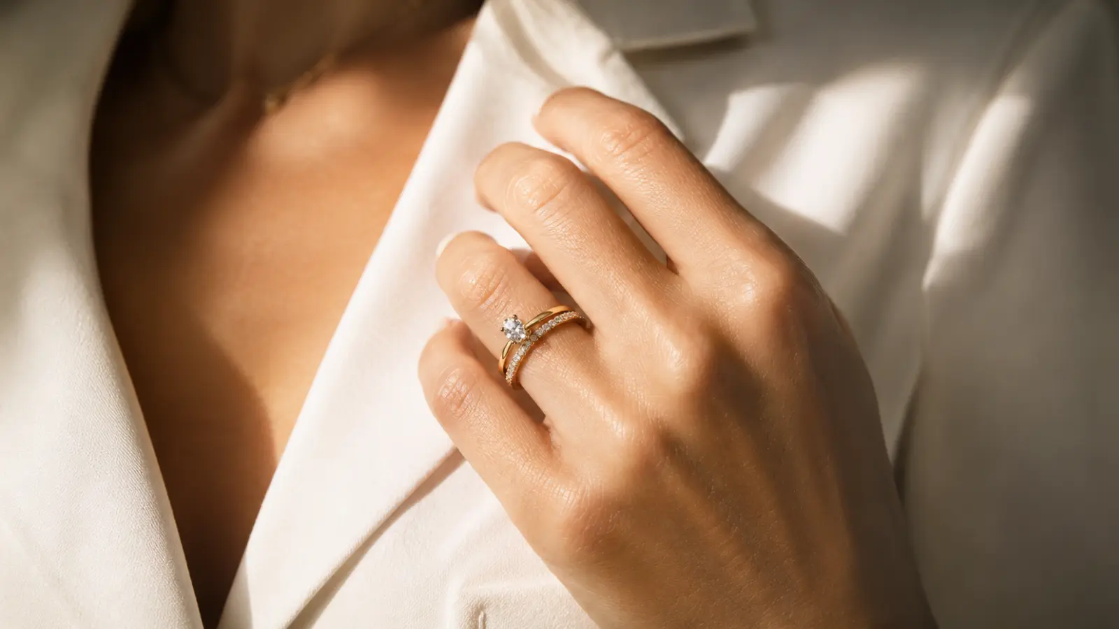 Close-up of engagement ring and wedding band worn together, showing the traditional way to arrange bridal rings on the finger.