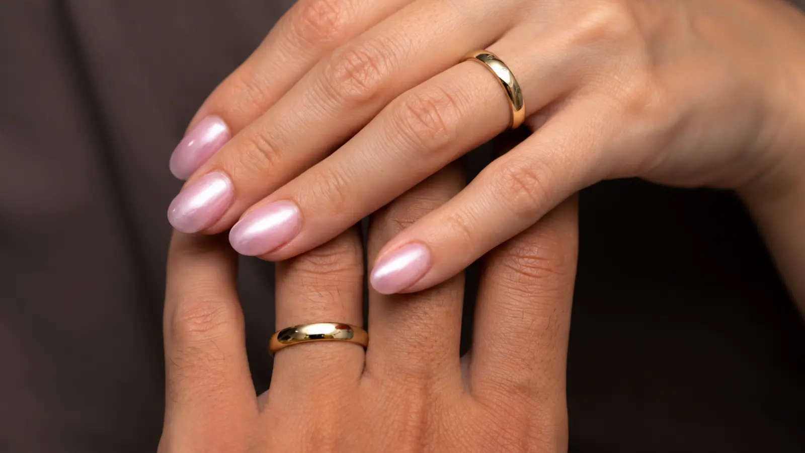 Gold wedding band and diamond engagement ring worn together as a complete bridal ring set.