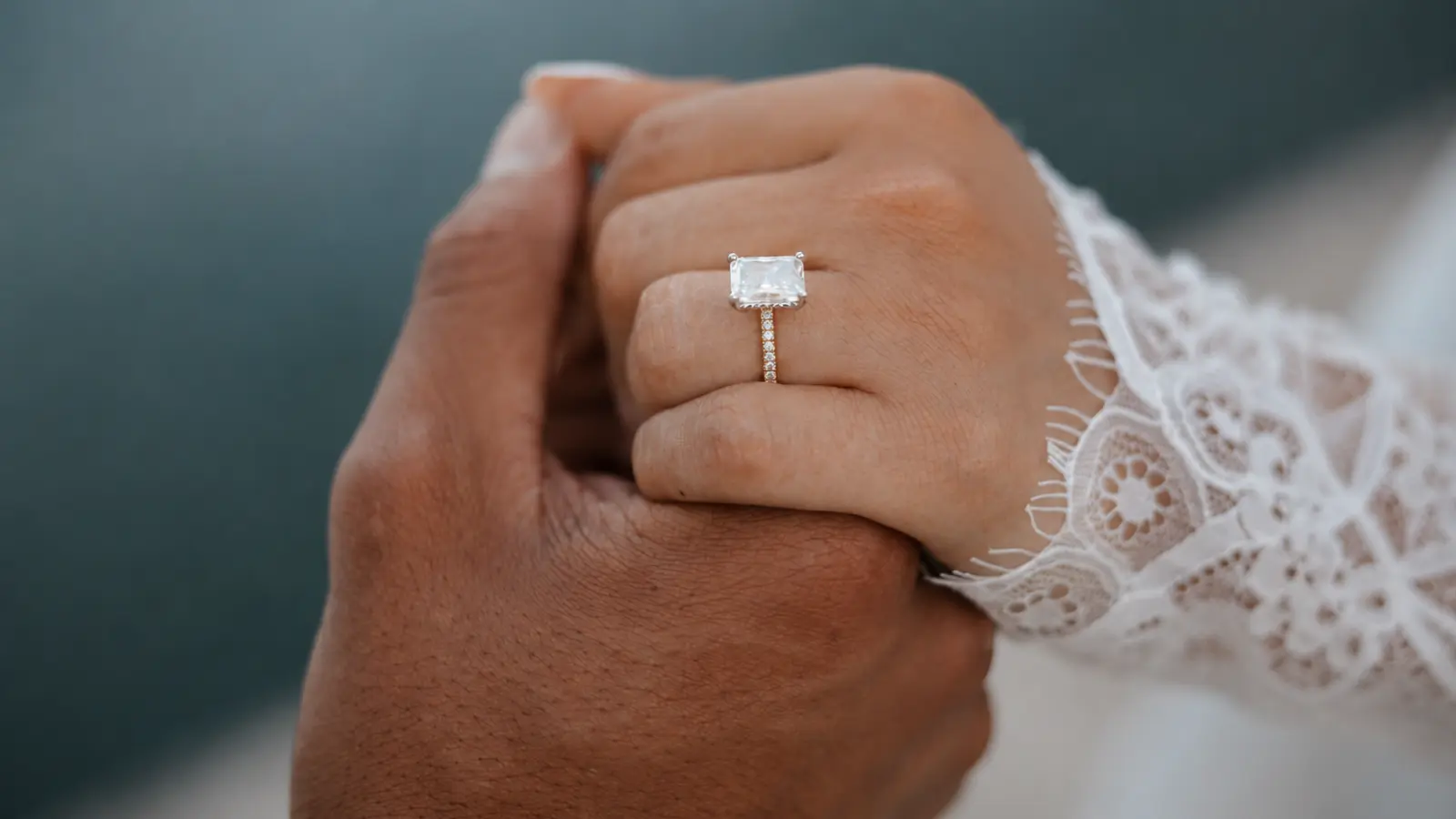 Close-up of a bride wearing a wedding ring on her left hand, representing the meaning behind traditional ring placement. What Hand Does a Wedding Ring Go On.