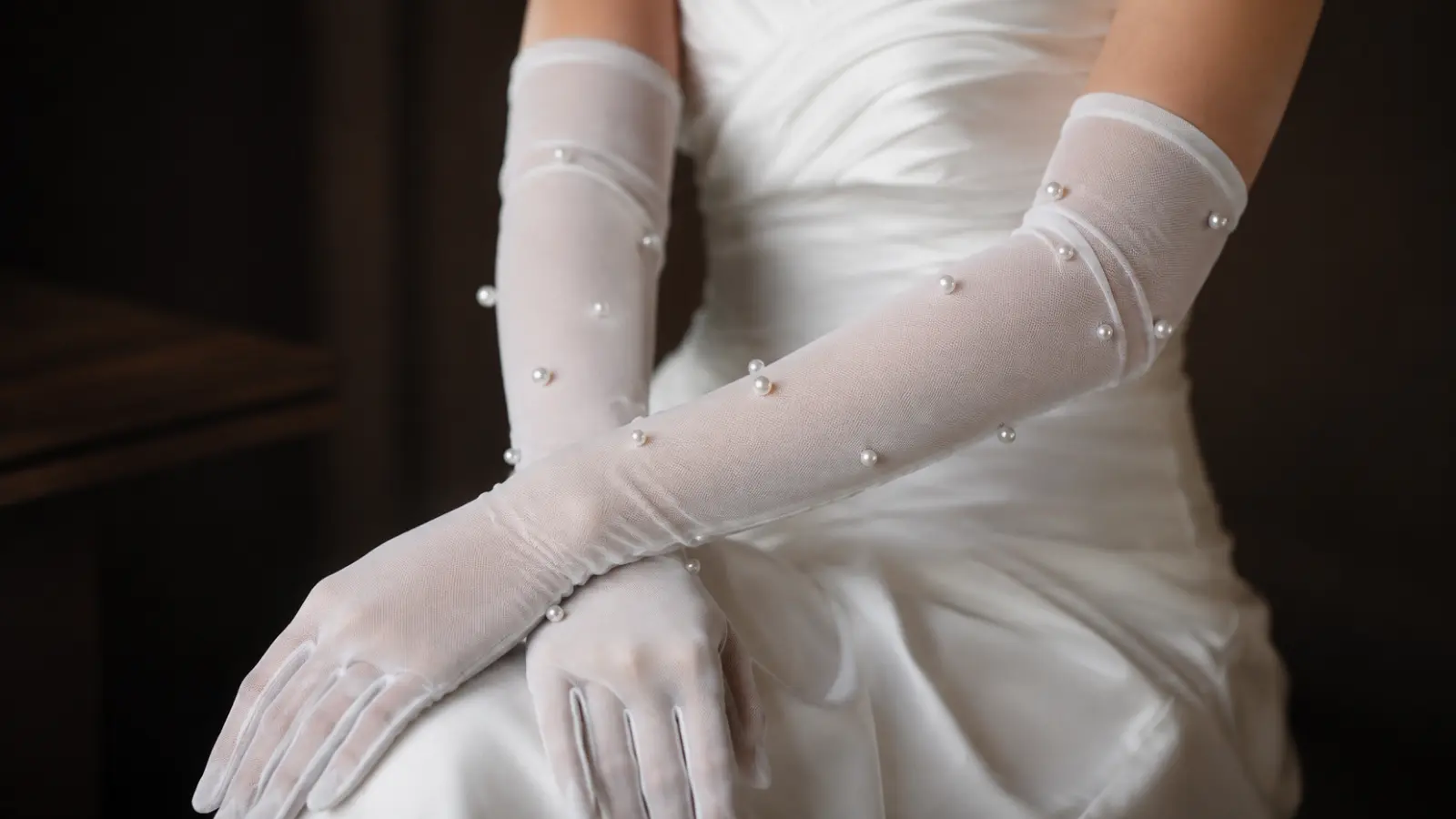 Long pearl wedding gloves styled with a white bridal dress, featuring an elegant and timeless wedding accessory idea