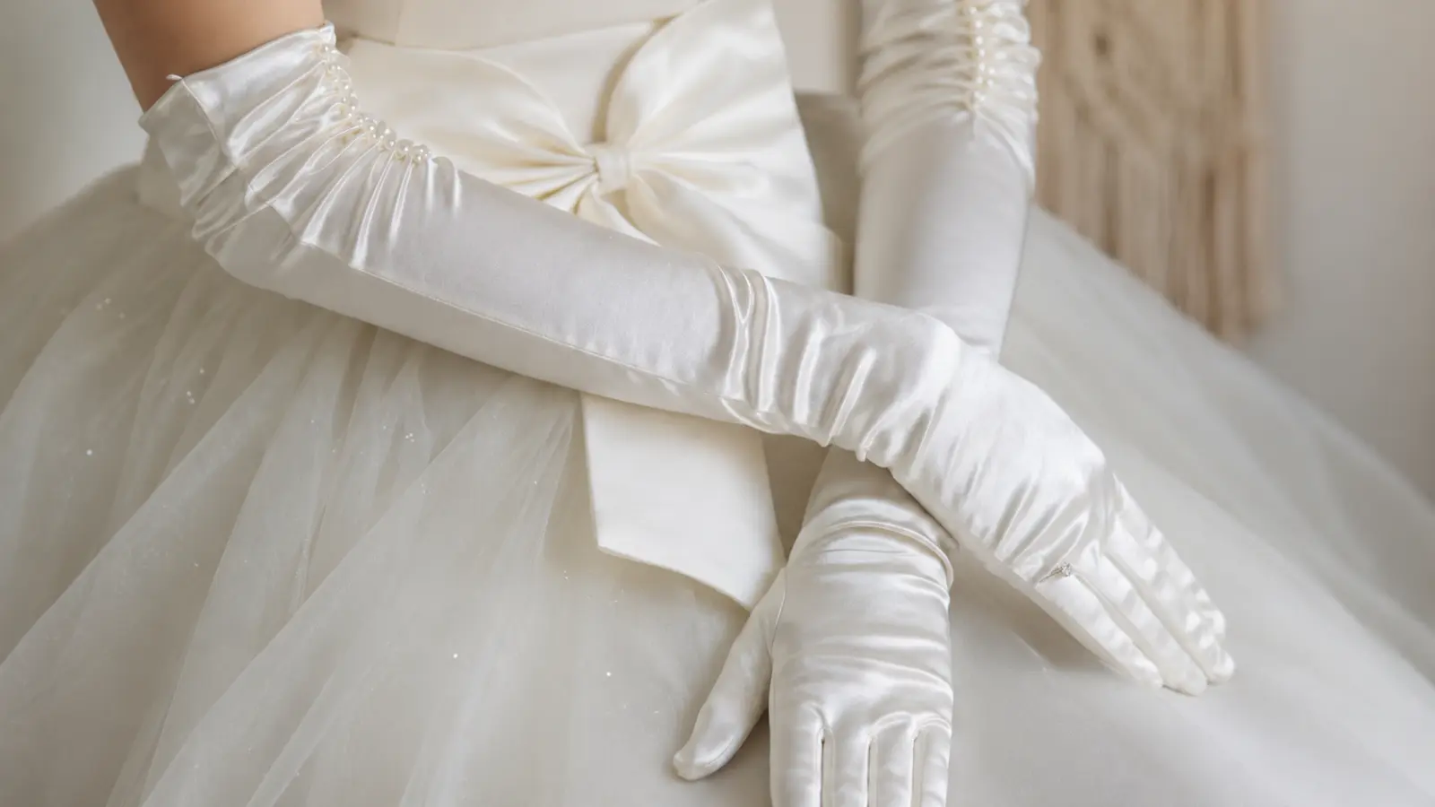 Bride wearing long white satin gloves with a wedding gown, highlighting elegant ways to style wedding dresses with gloves