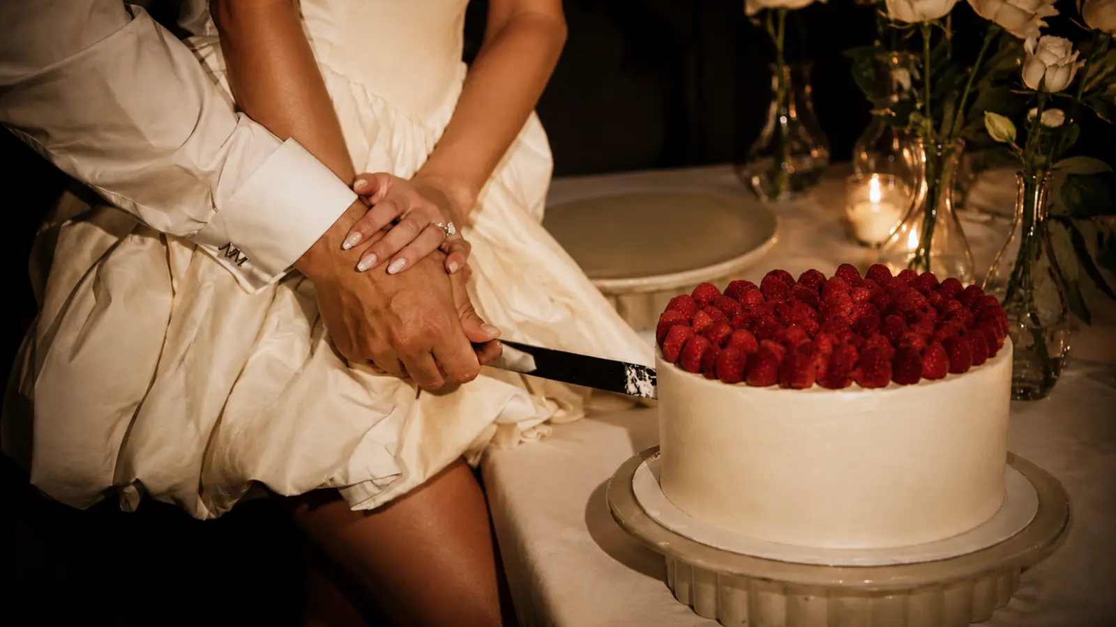 One tier raspberry wedding cake being cut