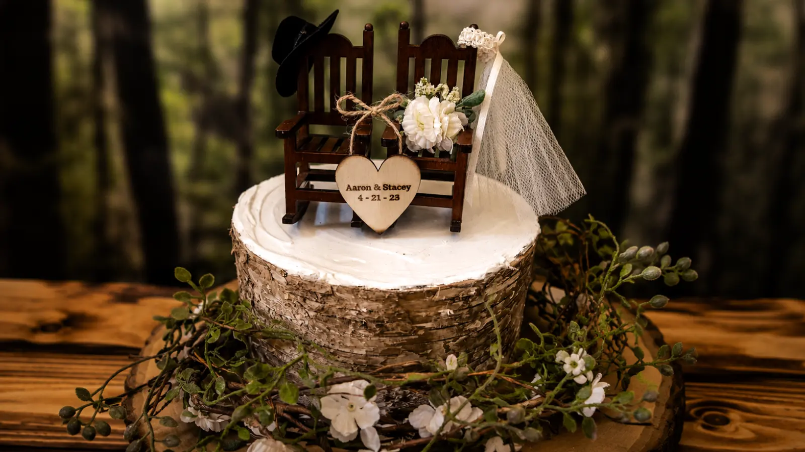 Rustic country wedding cake with greenery and wooden topper