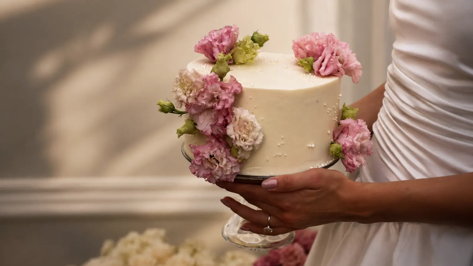 Simple floral wedding cake with pink flower decorations