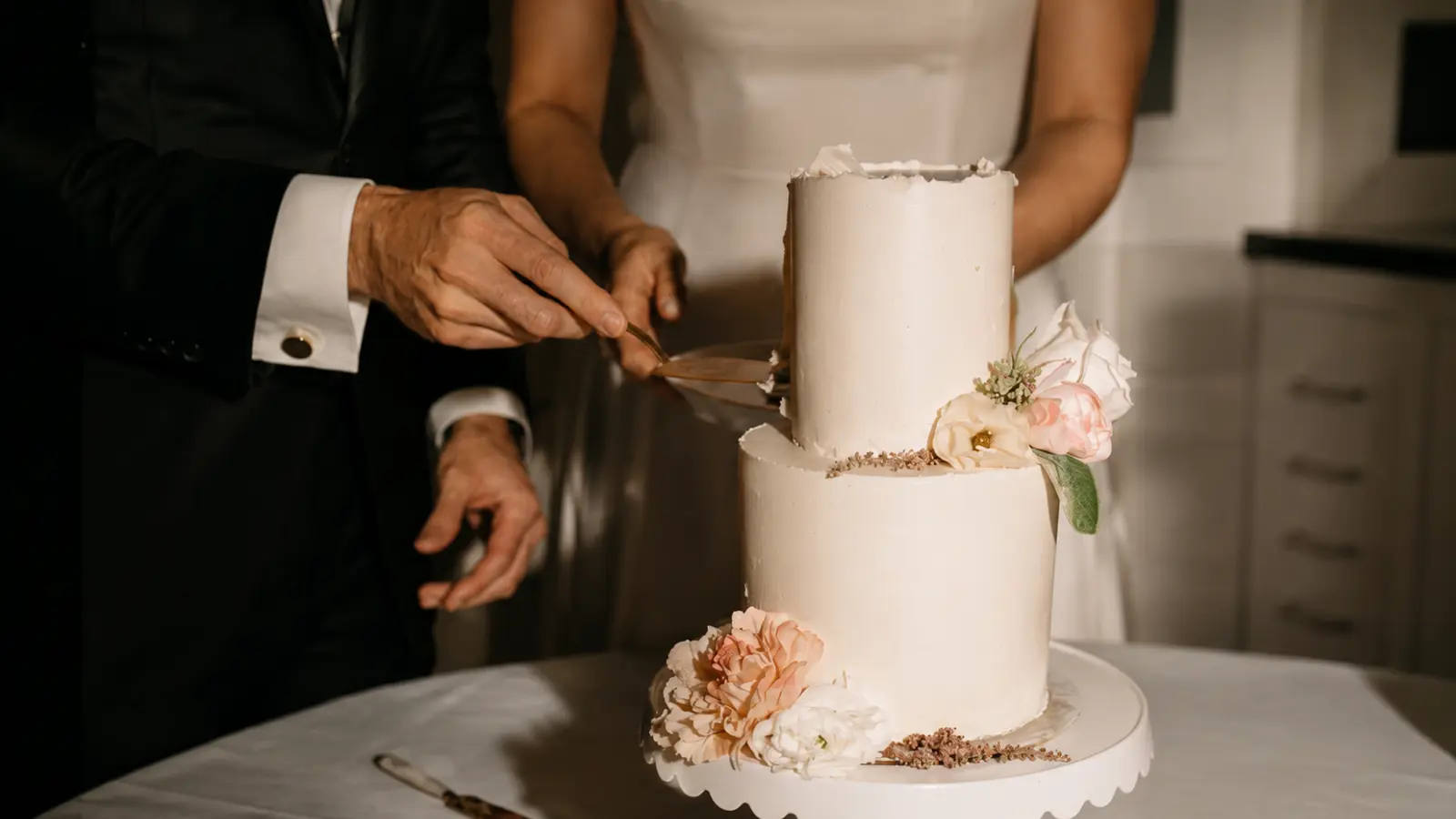 Small two tier wedding cake with fresh flowers