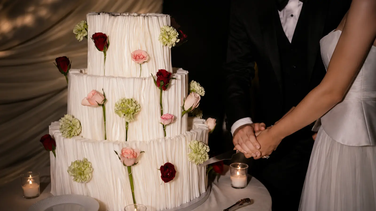 Three tier wedding cake with fresh flowers
