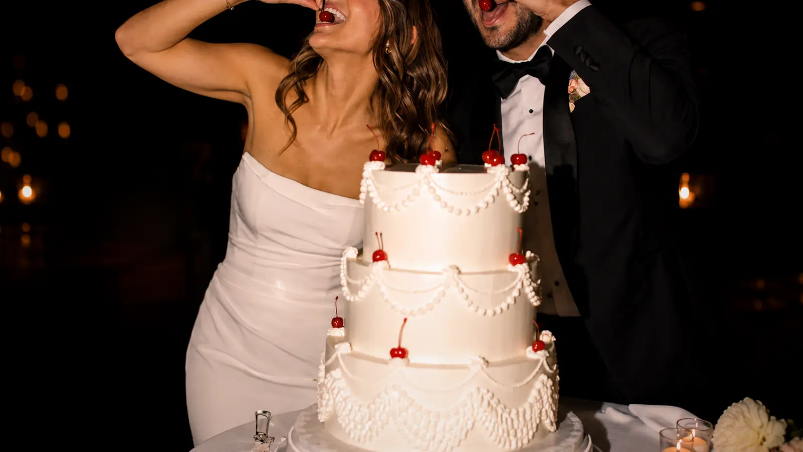 Three-tier wedding cake with cherries