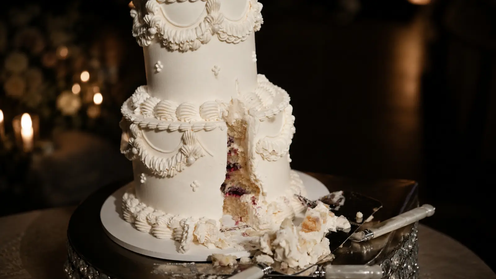 Two-tier wedding cake with slice removed
