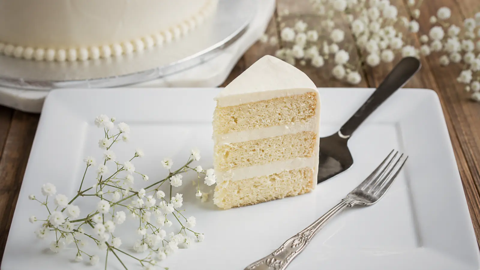Vanilla wedding cake slice with white frosting