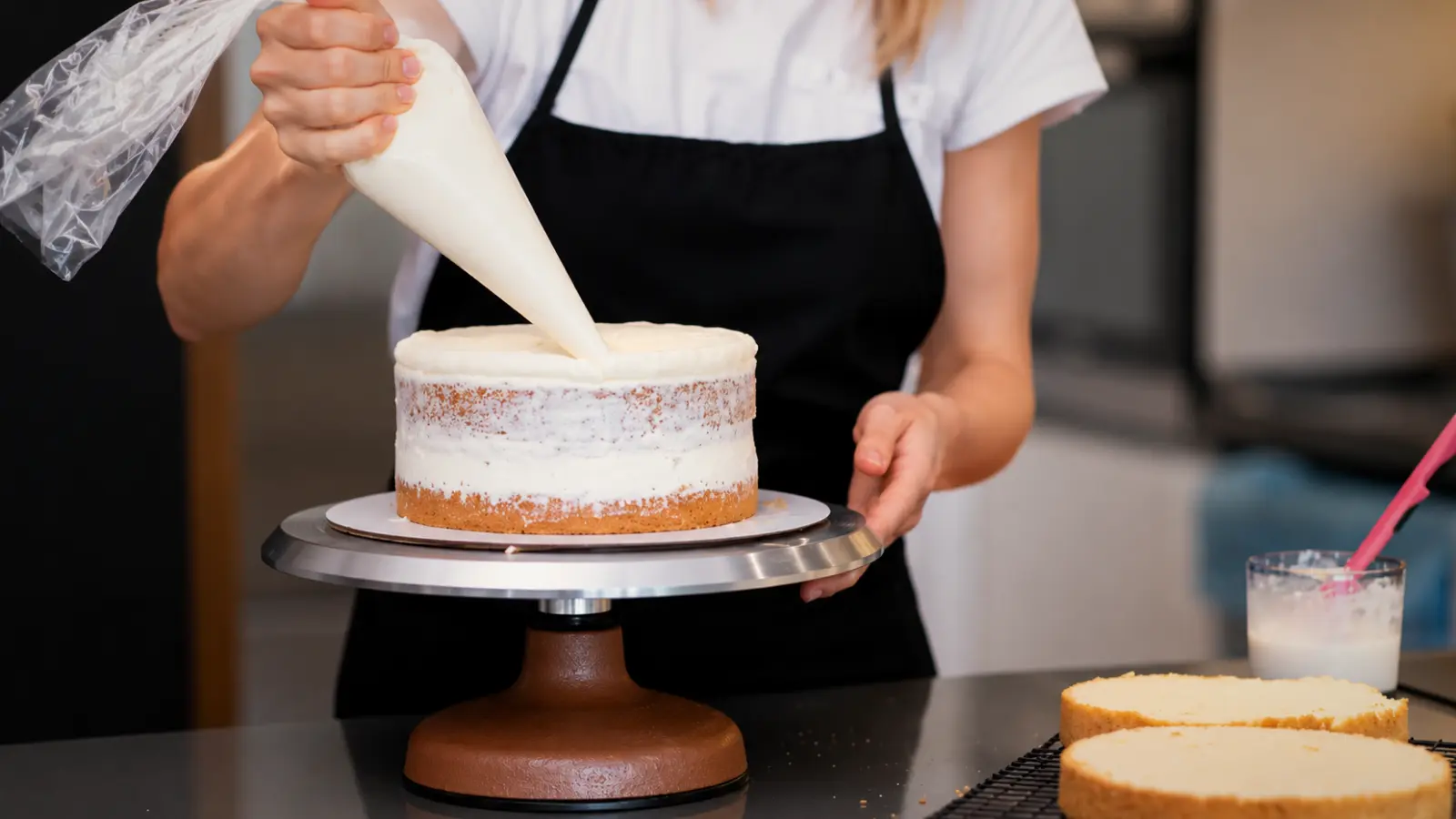 Wedding cake baker decorating a cake