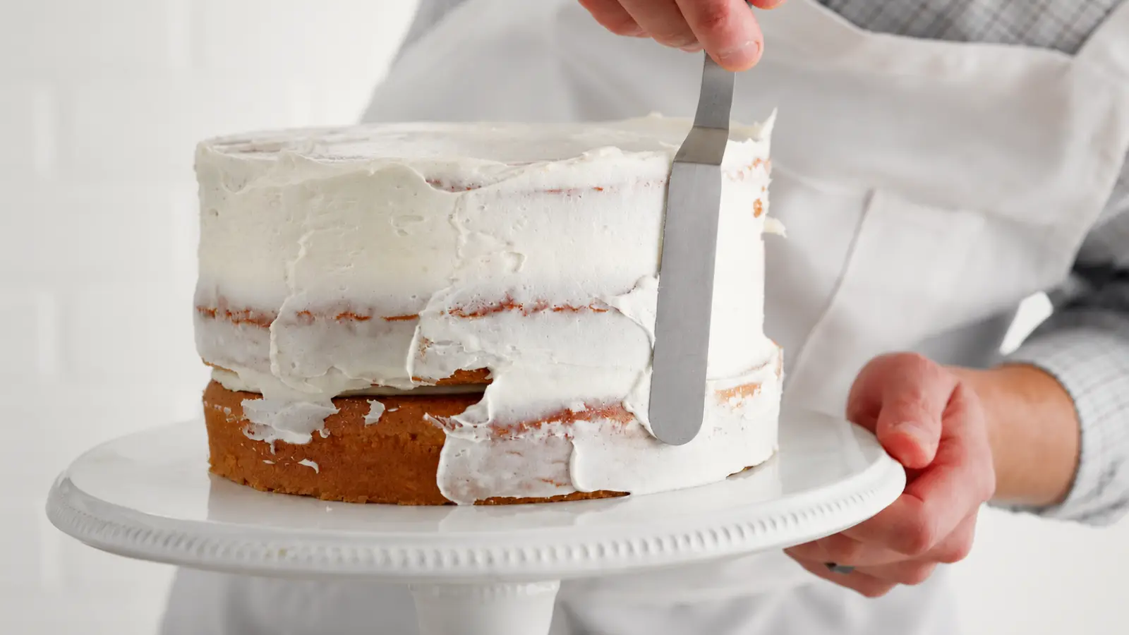 Wedding cake baker frosting a custom cake