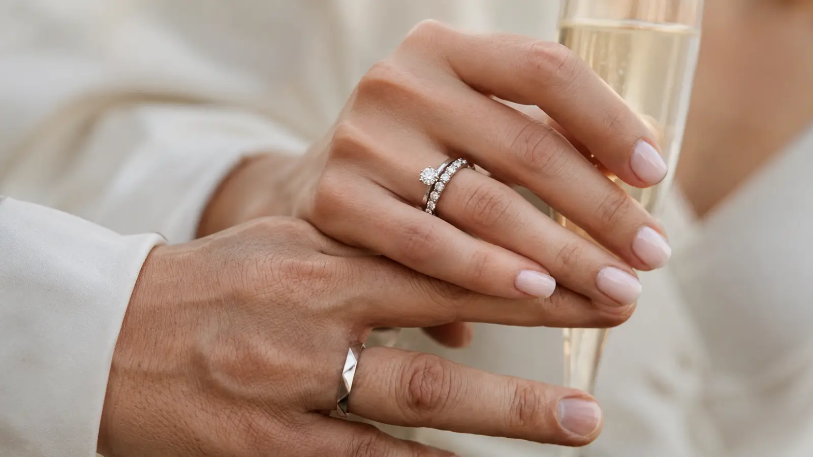 Couple wearing wedding rings and bands together, showing different styles and meanings.