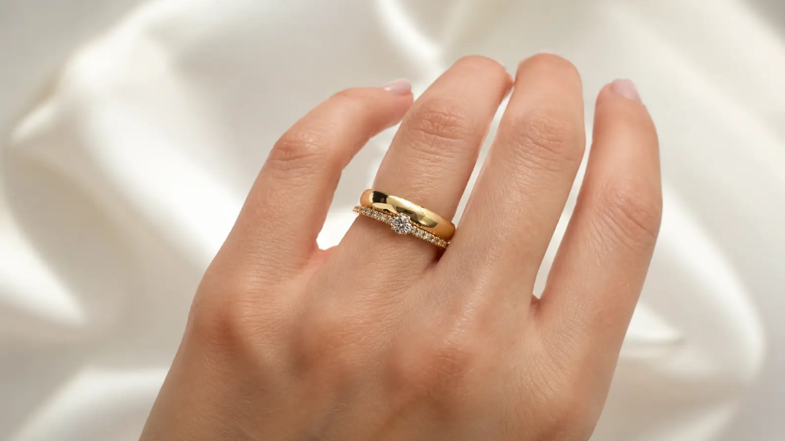 Wedding ring and engagement ring stacked together showing how to wear both rings.