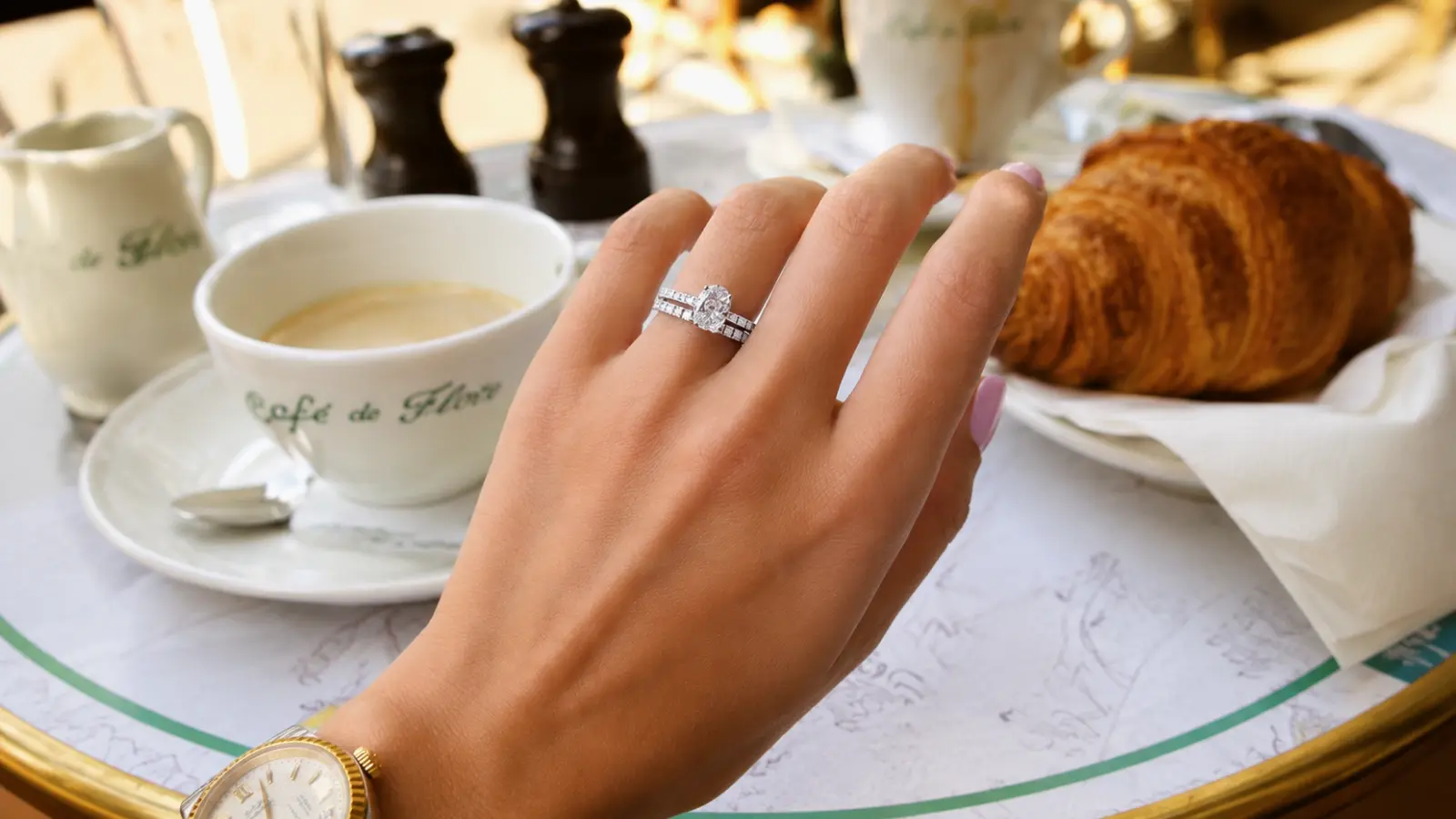 Bride’s hand wearing a wedding ring in a lifestyle setting, showing everyday wedding ring style and inspiration.