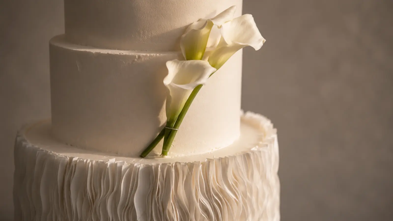 White floral wedding cake with calla lily decorations