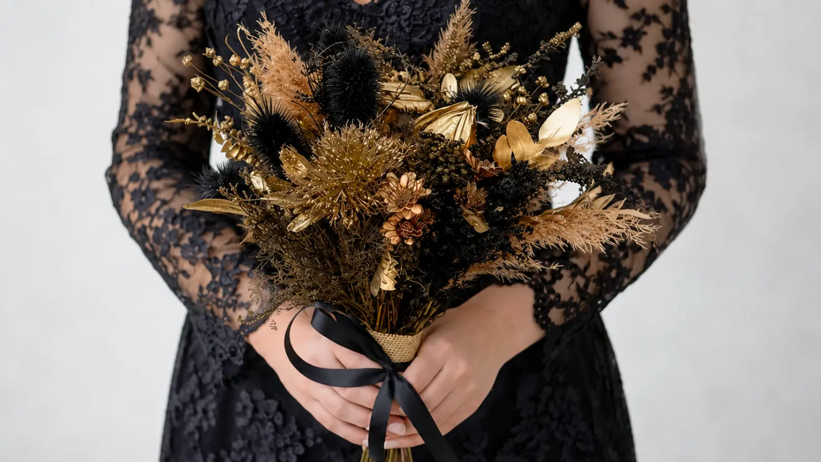 Bride holding a black and gold wedding bouquet