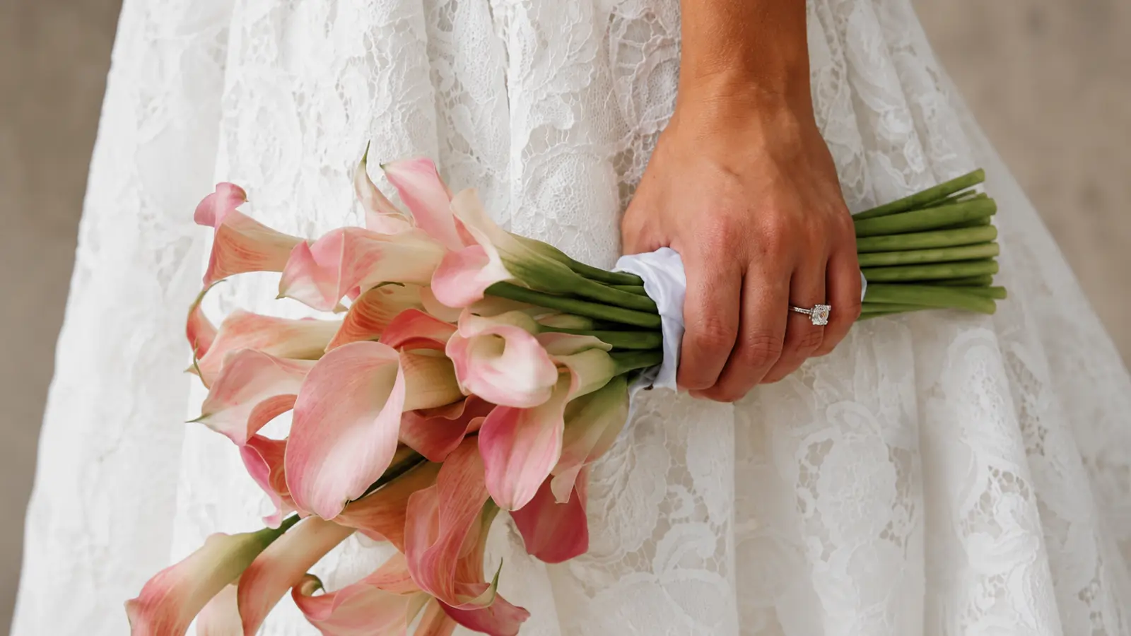 Bride holding a blush artificial wedding bouquet made with real-touch calla lilies