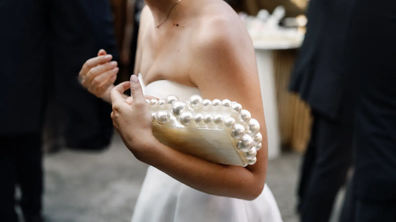 Bride holding a pearl bridal clutch as an alternative to a wedding bouquet