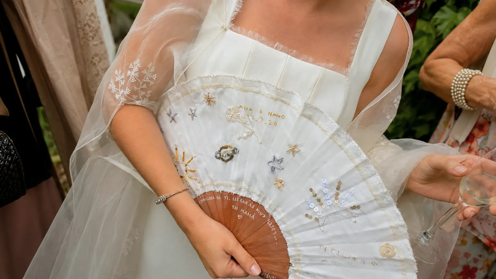 Bride carrying an embroidered bridal fan instead of a wedding bouquet Wedding Without a Bouquet