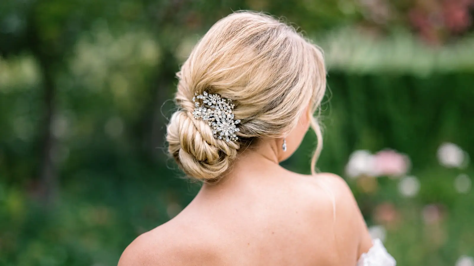 Bride wearing an elegant bridal updo with a sparkling hair accessory instead of a wedding veil, showcasing a modern and sophisticated alternative bridal hairstyle