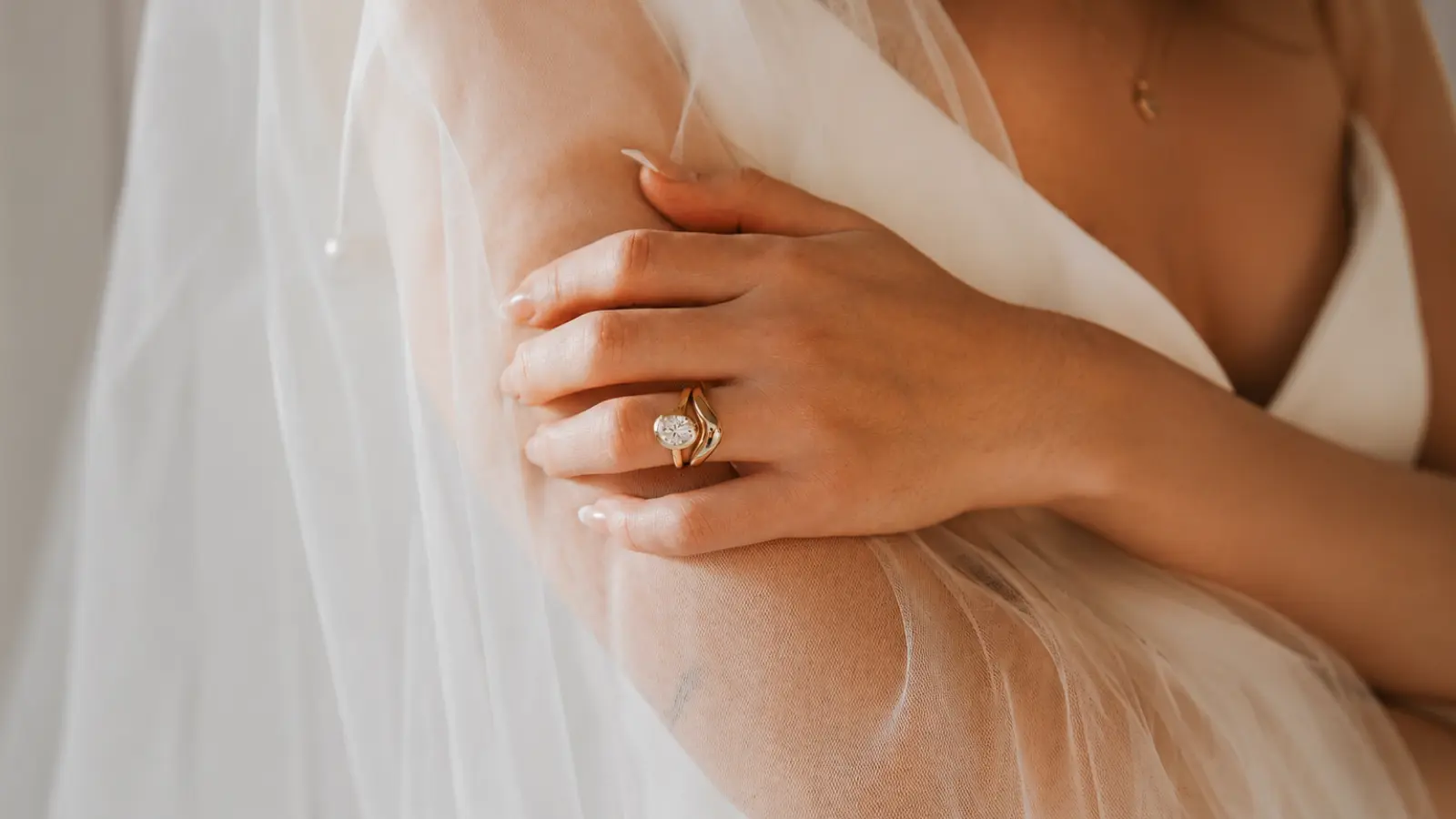 Bride wearing a coordinated diamond engagement ring and matching wedding band