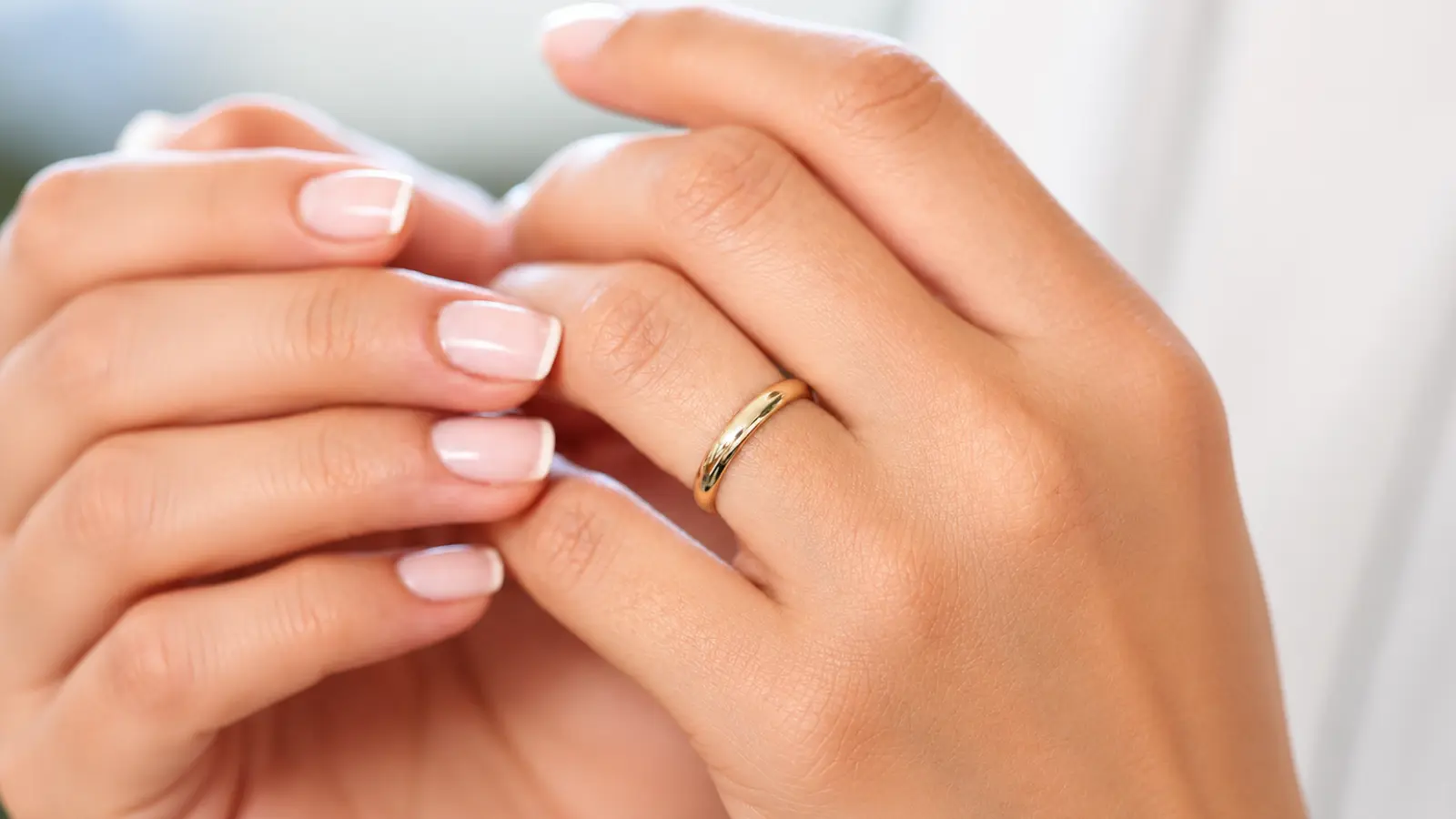 Classic polished yellow gold wedding rings band on a woman's hand