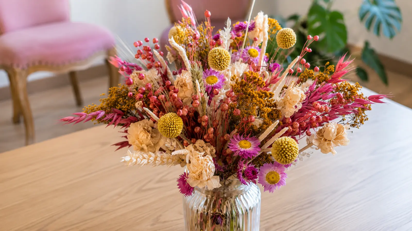 Colorful dried flower arrangement featuring preserved flowers berries grasses and textured botanical elements