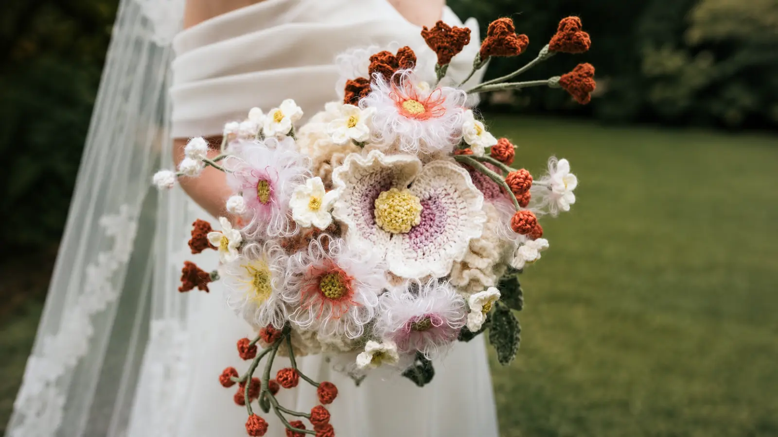 Bride holding a handmade crochet wedding bouquet with floral details