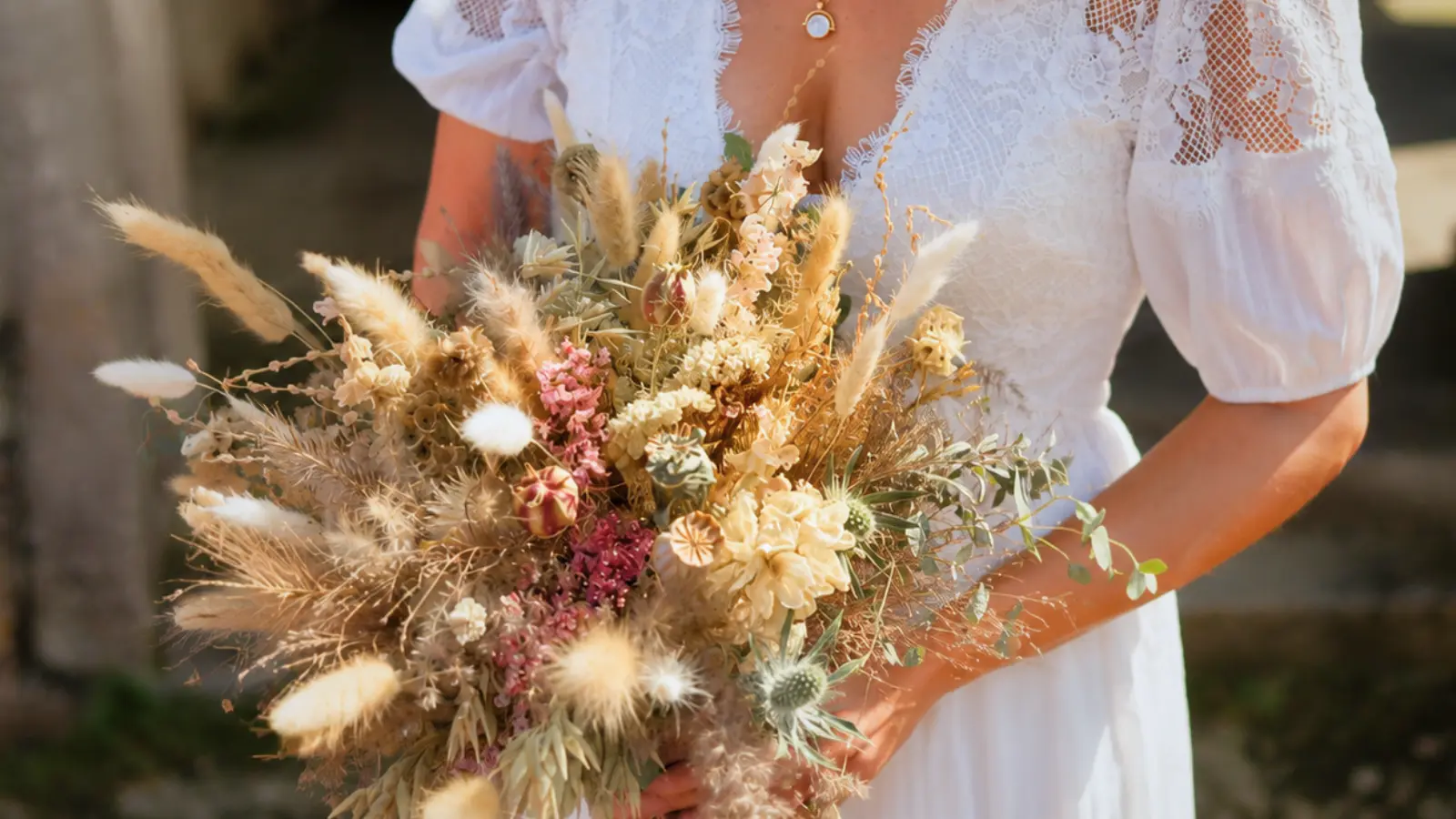 Bride holding a dried flower wedding bouquet with preserved botanical elements