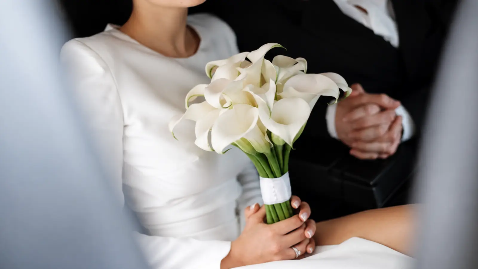 Bride holding an elegant white calla lily city hall wedding bouquet