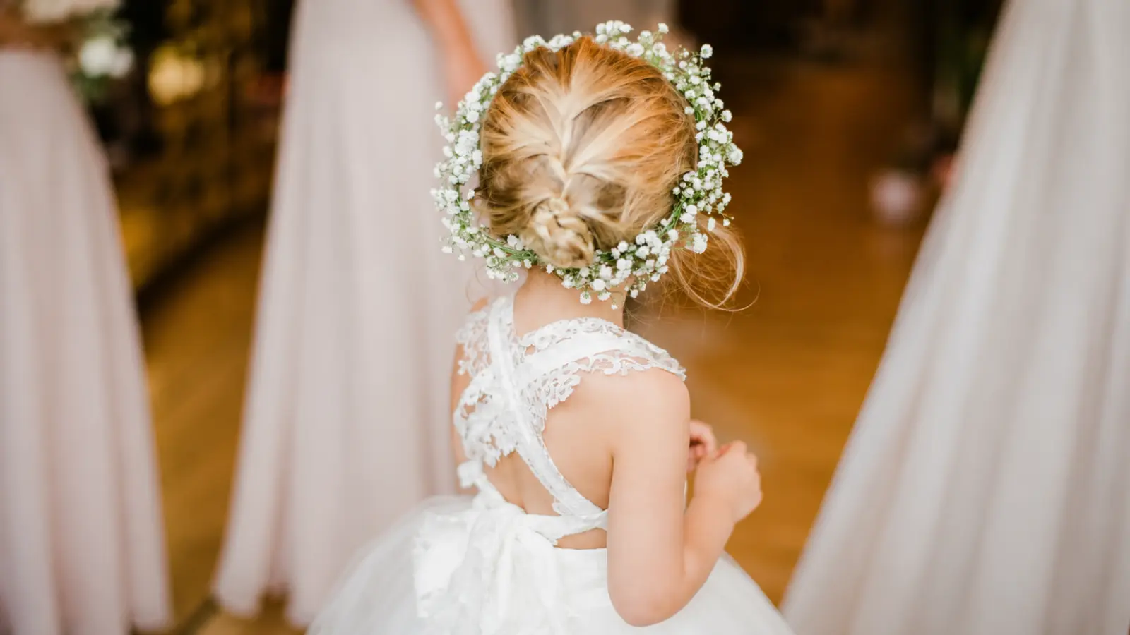 Flower girl wearing a baby's breath flower crown with a braided hairstyle