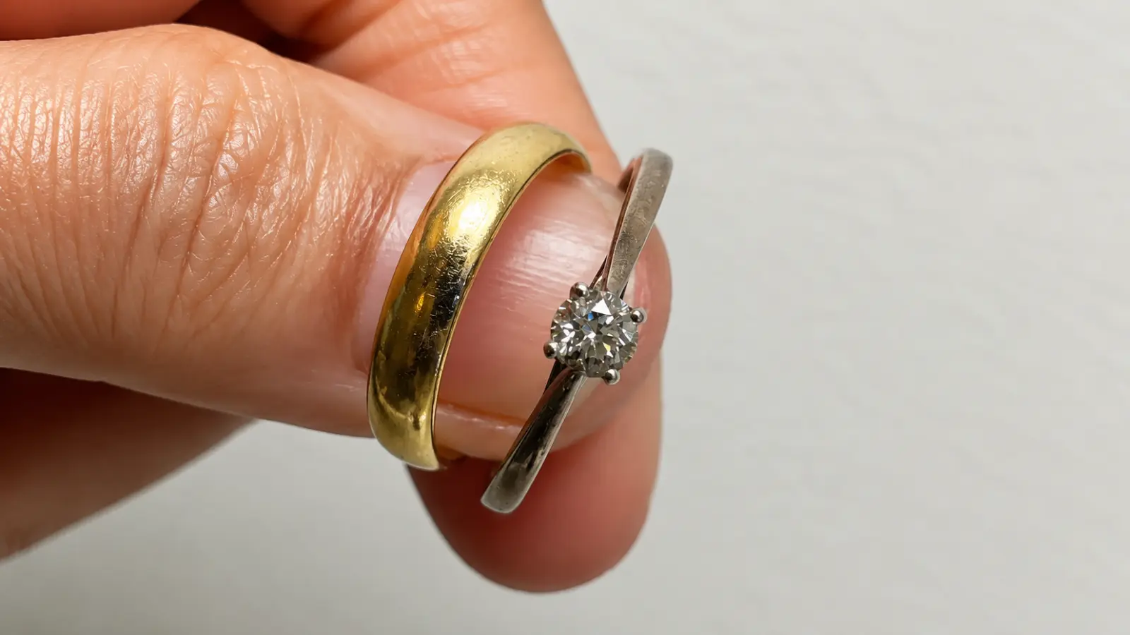 A found engagement ring and wedding band held together after being successfully recovered from being lost