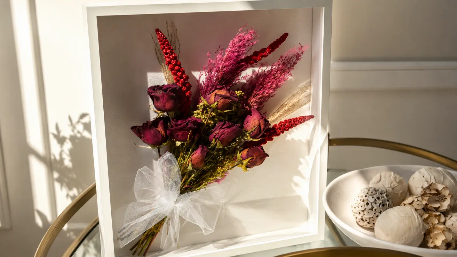 Framed preserved wedding bouquet displayed as wall art